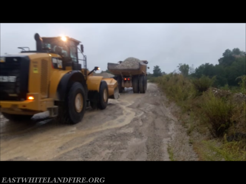 Glasgow Quarry equipment building a stable road and work area before the rescue of dump truck operator. South rim of quarry.